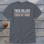 Gray t-shirt with "THESE HOLLERS KNOW MY NAME" text.