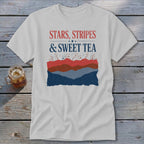 A light gray crewneck t-shirt featuring a red, white, and blue graphic with text that reads Stars, Stripes & Sweet Tea.