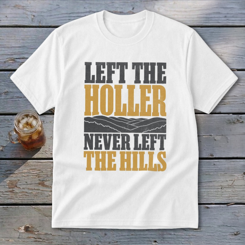 White t-shirt with text "LEFT THE HOLLER NEVER LEFT THE HILLS" and a landscape.