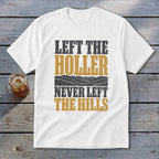 White t-shirt with text "LEFT THE HOLLER NEVER LEFT THE HILLS" and a landscape.