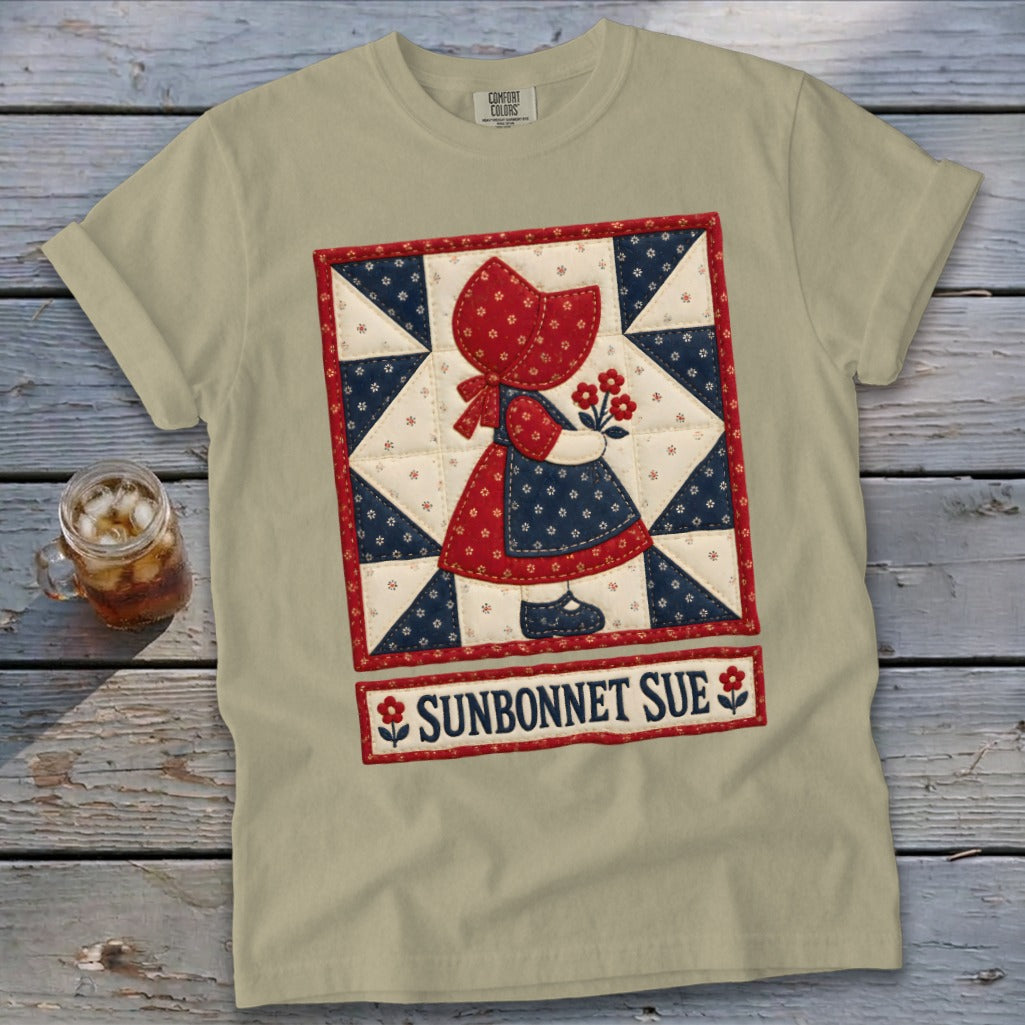 Tan t-shirt with a quilt design of Sunbonnet Sue holding flowers, and text.