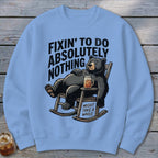 Light blue crewneck sweatshirt featuring a graphic of a black bear relaxing in a rocking chair with text.