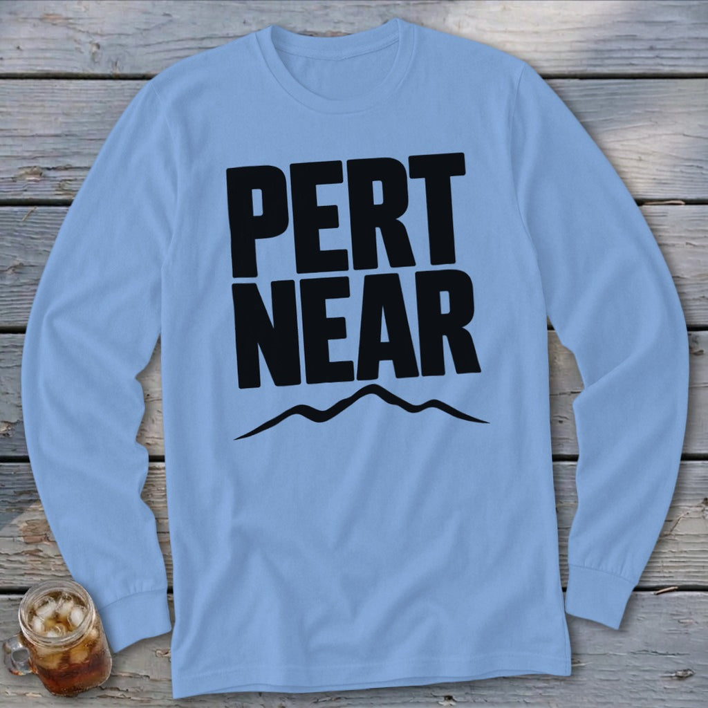 Light blue long-sleeve t-shirt with black block lettering reading PERT NEAR above a mountain outline.