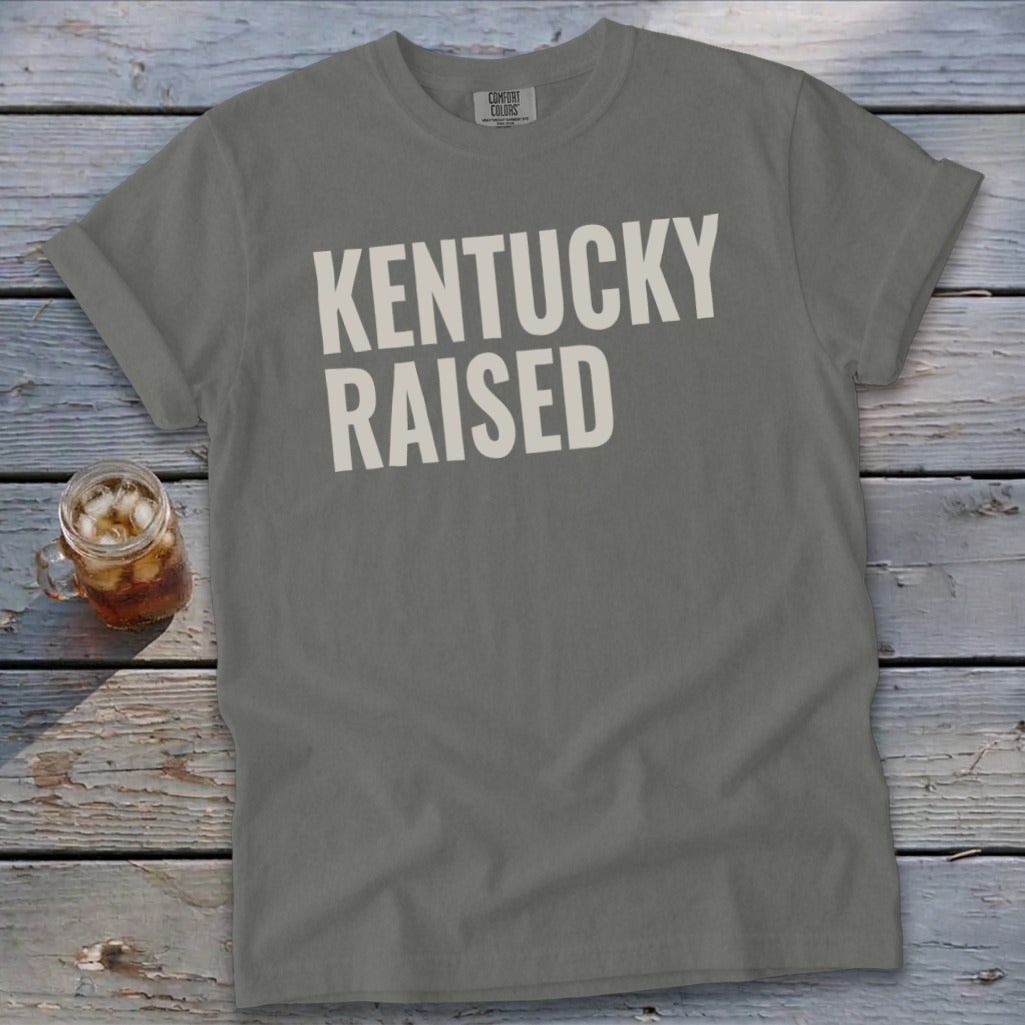 Grey Comfort Colors t-shirt with "KENTUCKY RAISED" in white text.