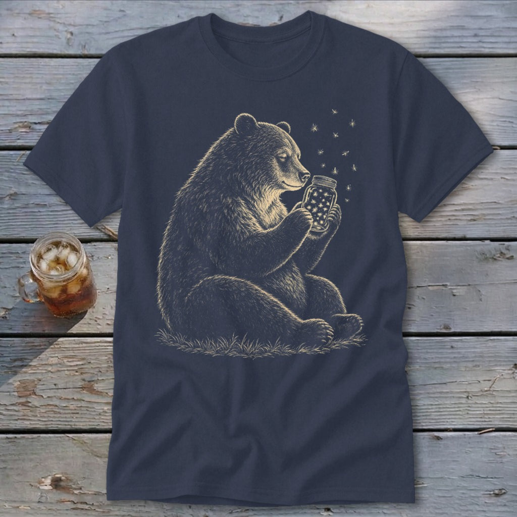 Bear sitting and holding a jar of fireflies on a navy blue t-shirt.