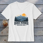 White t-shirt with "RIDGE RUNNER MORNING" text and mountain sunset graphic.