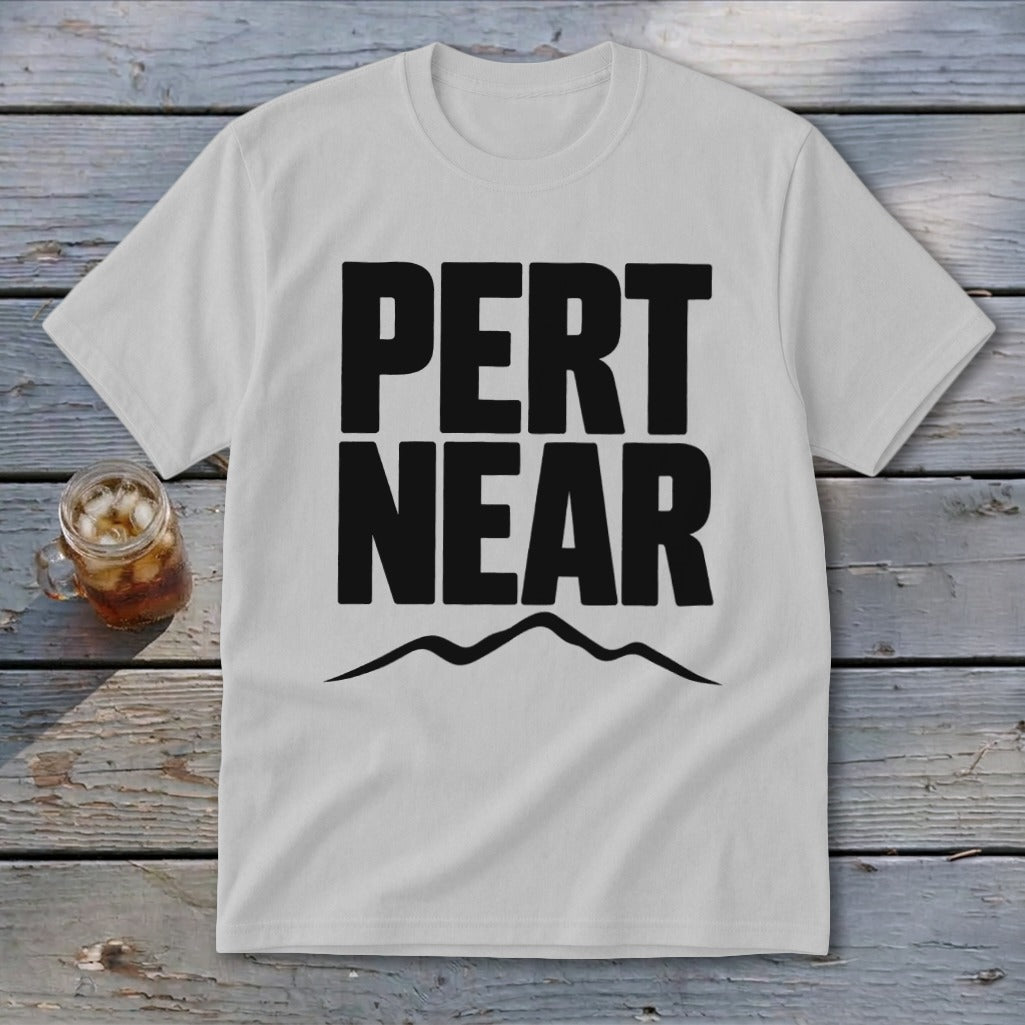 A light gray crewneck t-shirt with bold black text that reads PERT NEAR above a mountain range graphic.