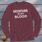 Maroon long-sleeve t-shirt with "Mountains In My Blood" printed in white text.
