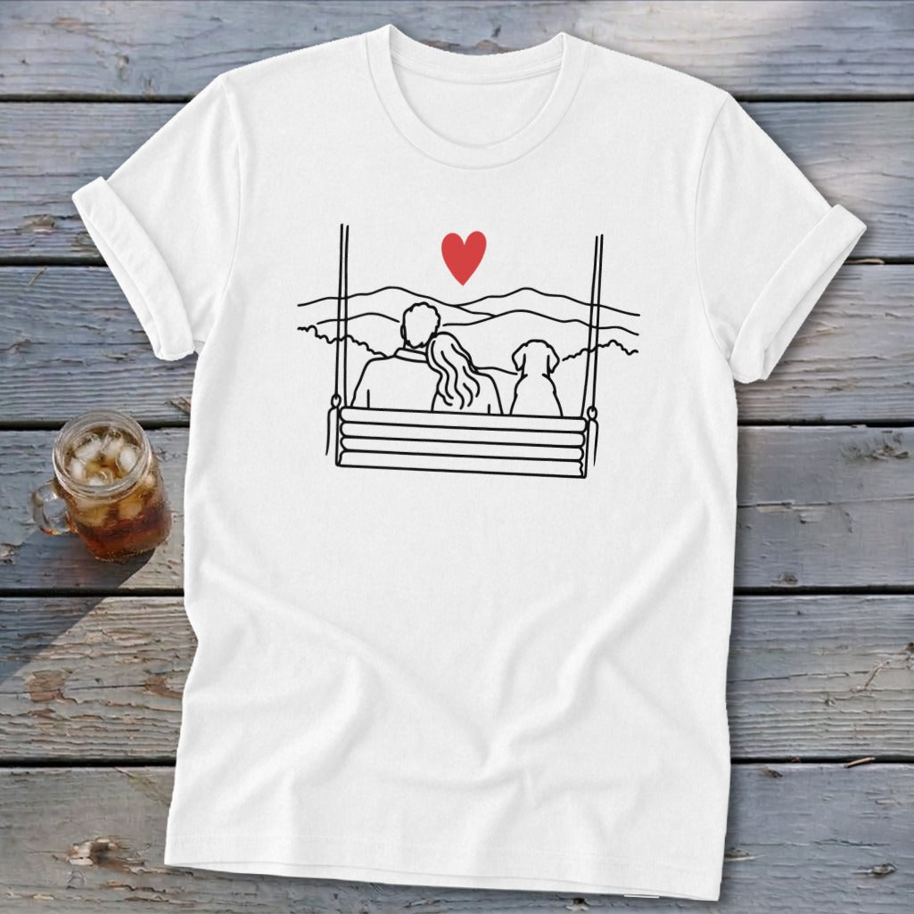 Couple and dog on a swing overlooking mountains with a red heart above.