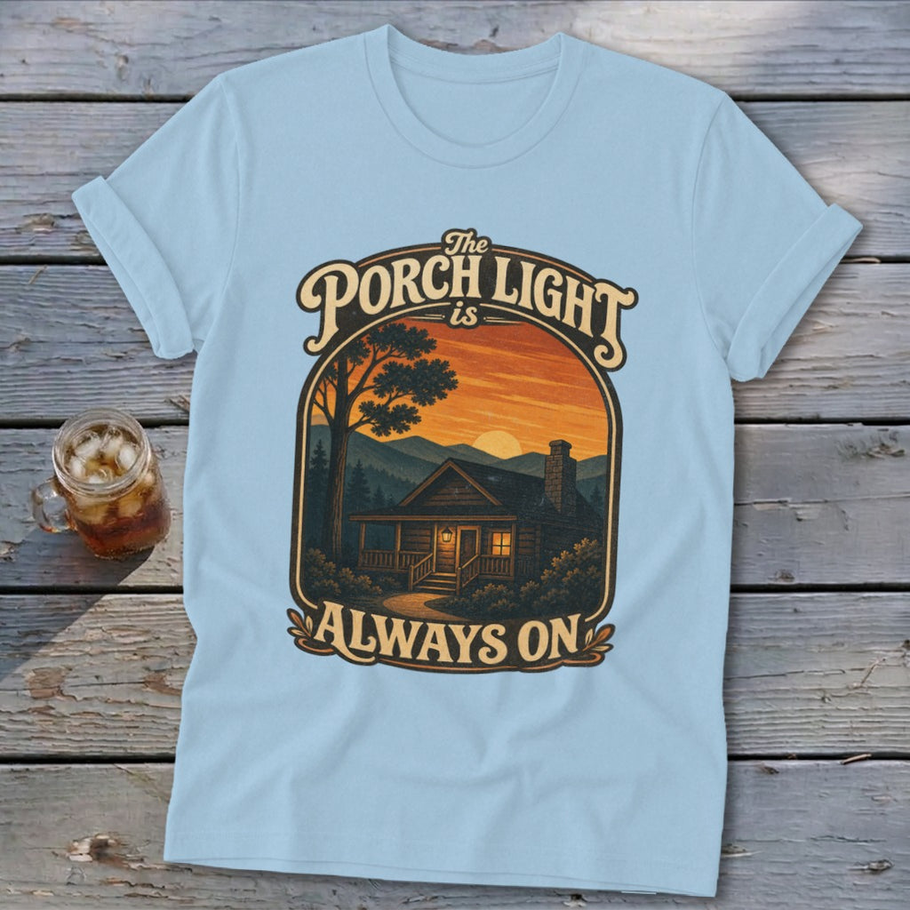 Light blue t-shirt with cabin scene and text "The Porch Light is Always On".