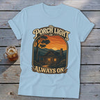 Light blue t-shirt with cabin scene and text "The Porch Light is Always On".