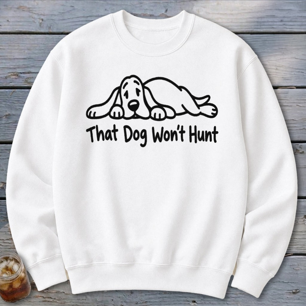 A white crewneck sweatshirt features a black line drawing of a resting hound dog and the text That Dog Won't Hunt.