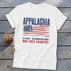 A white t-shirt features distressed text reading Appalachia, 13 States, One Mountain Range, and One Free Country, above a weathered American flag.