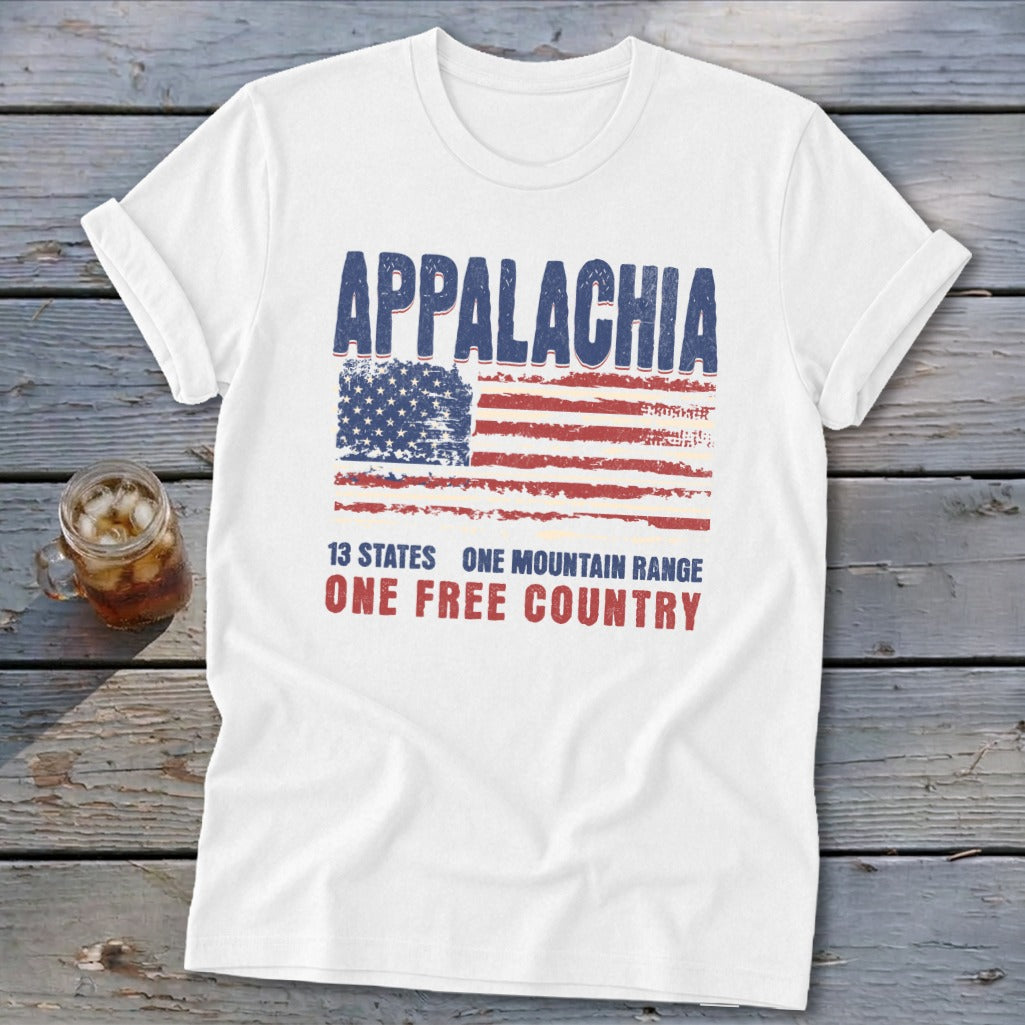 A white t-shirt features distressed text reading Appalachia, 13 States, One Mountain Range, and One Free Country, above a weathered American flag.