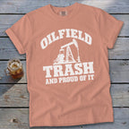 Peach Comfort Colors t-shirt with "Oilfield Trash And Proud Of It" text and oil pump graphic.