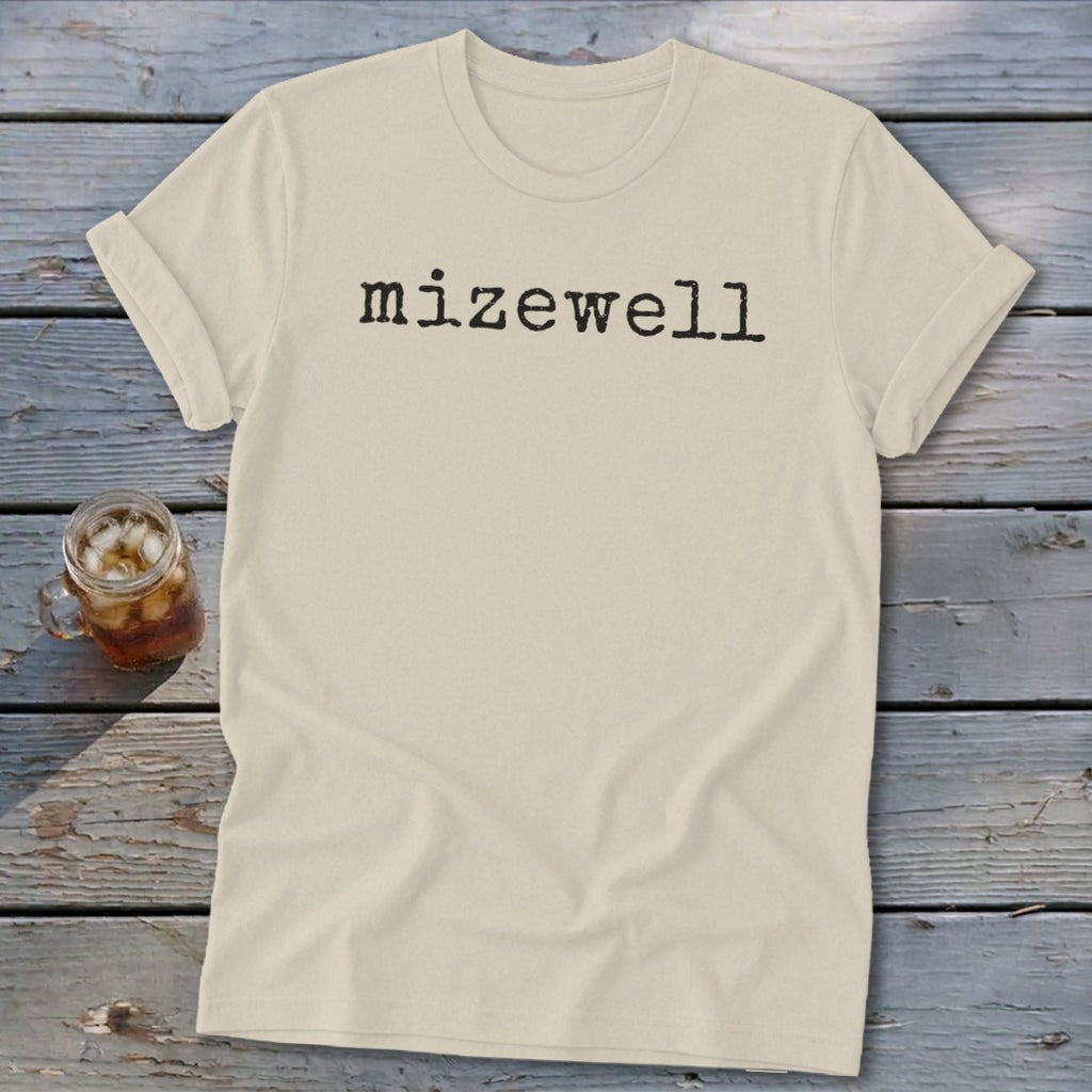 Cream t-shirt with black text "mizewell" in typewriter font.