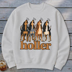 Four dogs howling above the text "holler" on a white sweatshirt.