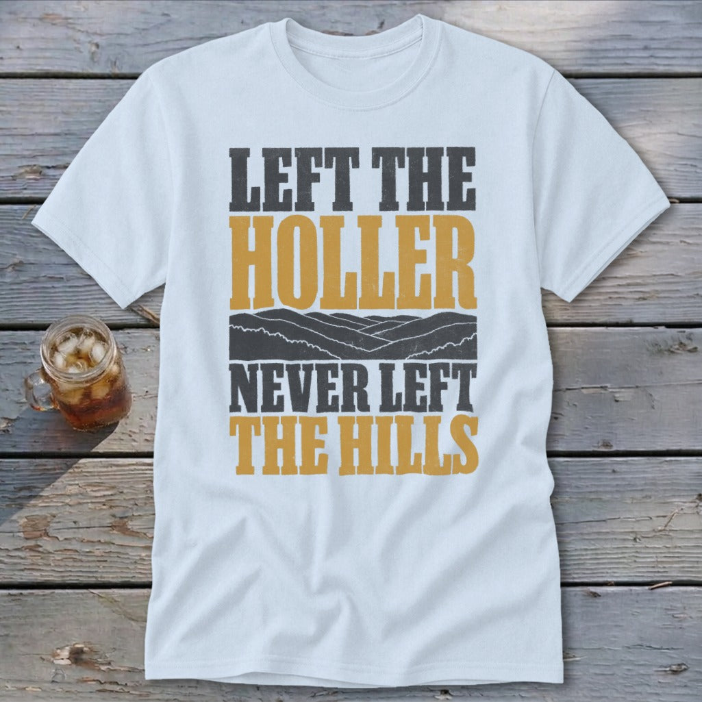 White t-shirt with "LEFT THE HOLLER NEVER LEFT THE HILLS" text and mountain graphic.