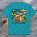 Turquoise t-shirt featuring a retro graphic of stacked pumpkins, hills, and the text Harvest Days in the Highlands.