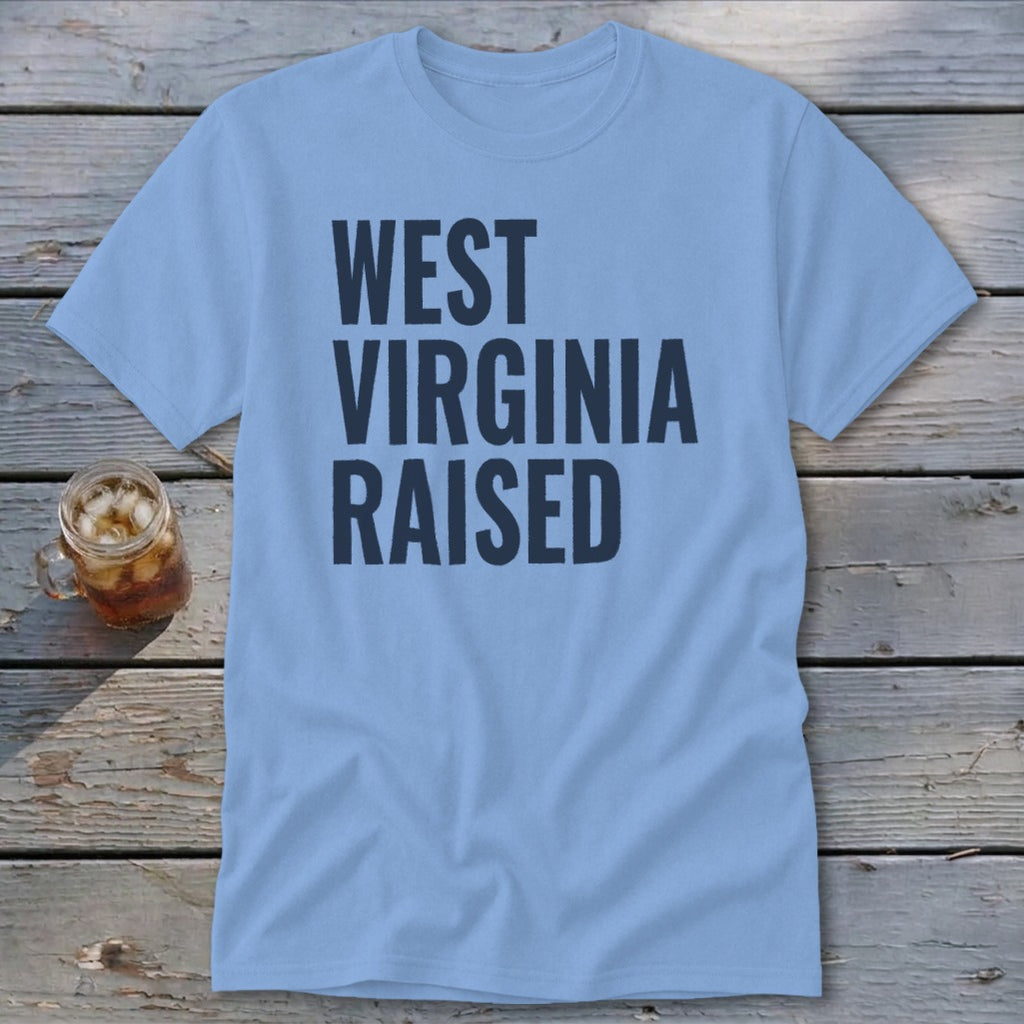 Light blue t-shirt with "WEST VIRGINIA RAISED" in dark blue text.