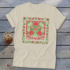 Cream t-shirt with red and green floral border and "Mountain Blood" text.