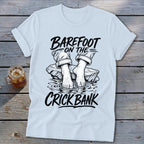 Light blue t-shirt with "Barefoot on the Crick Bank" graphic.