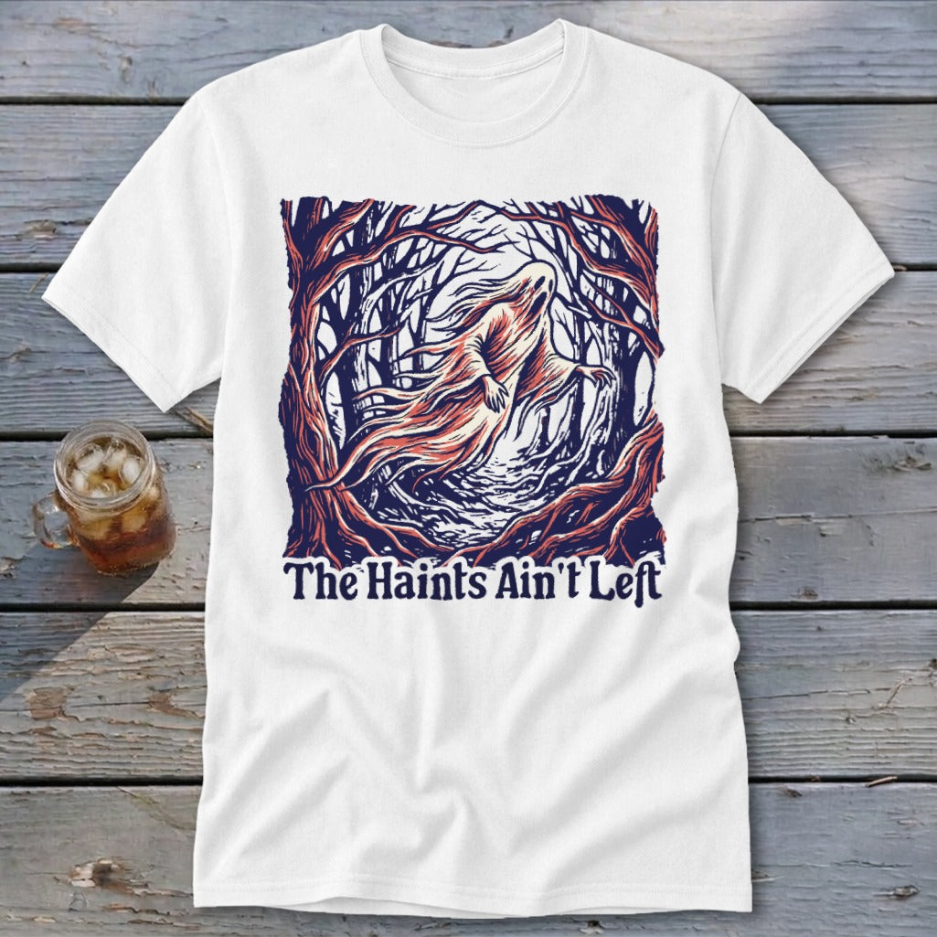 White t-shirt with a ghost in a dark forest and text "The Haints Ain't Left".
