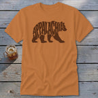 Orange t-shirt featuring a brown bear graphic composed of the word Appalachia on a wooden background.