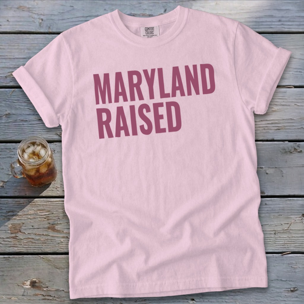 Pink t-shirt with "MARYLAND RAISED" text and a glass of iced tea.