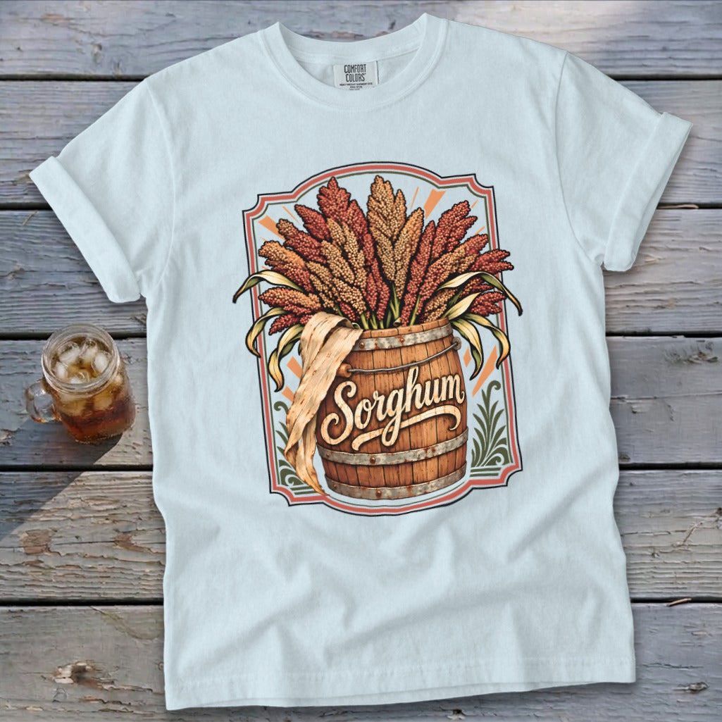 White t-shirt with a graphic of sorghum stalks in a wooden barrel.