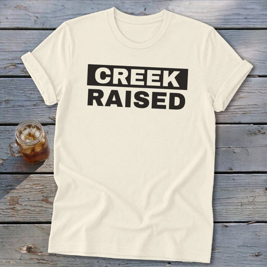 Cream t-shirt with "CREEK RAISED" in black text.