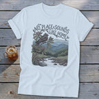 White t-shirt with illustration of bird, river, mountains, and text "No Place Sounds Like Home".