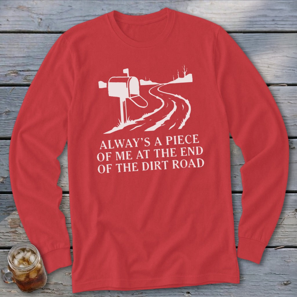 Red long-sleeve shirt with white graphic of a mailbox and dirt road, text reads "Always a piece of me at the end of the dirt road."