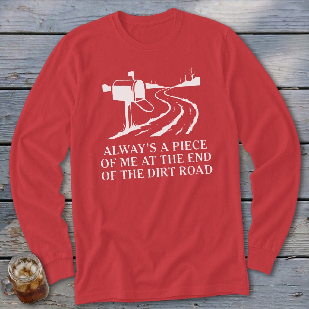 Red long-sleeve shirt with white graphic of a mailbox and dirt road, text reads "Always a piece of me at the end of the dirt road."