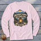 Pink long sleeve shirt with a graphic featuring a lantern and mountains, reading "Always Leave the Light On COME ON IN".