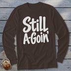 Brown long-sleeve shirt with the white text Still A-Goin centered on the chest.
