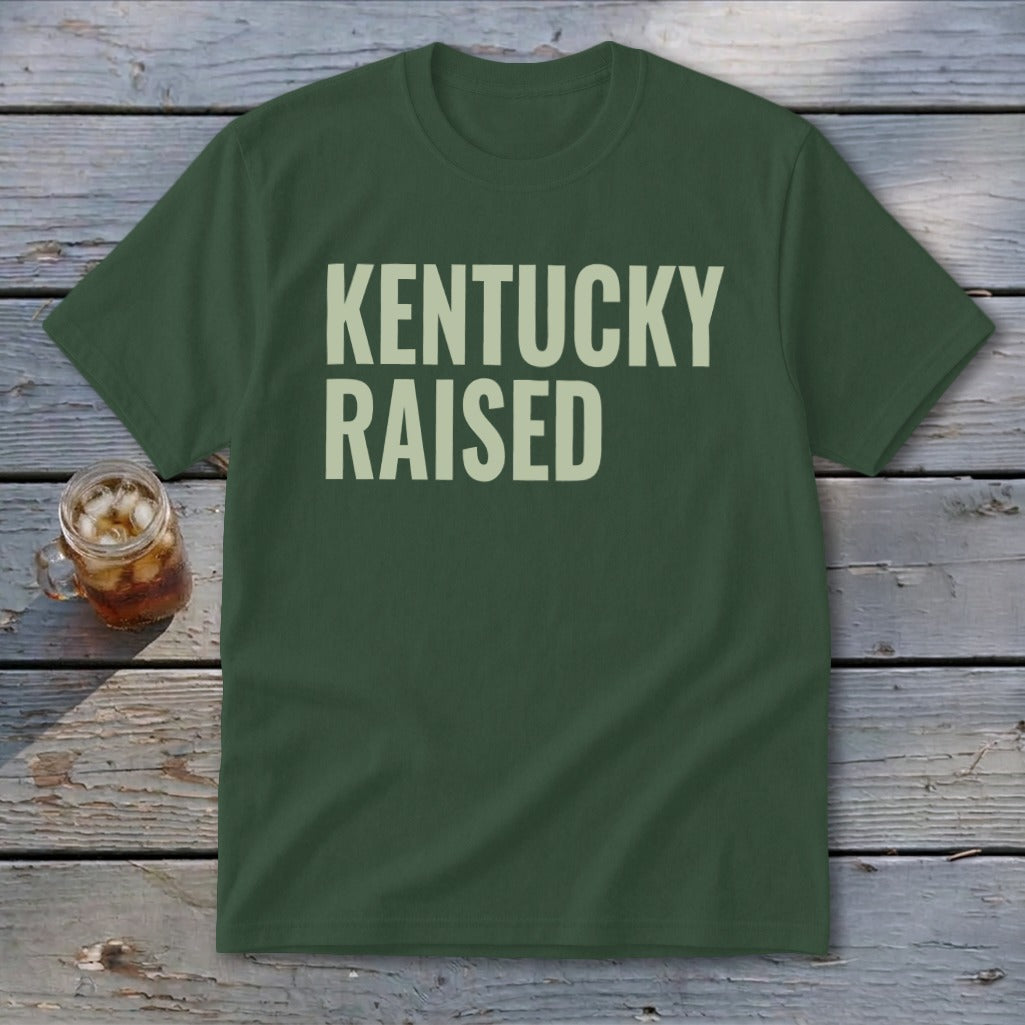 Dark green t-shirt with "KENTUCKY RAISED" in light beige text.
