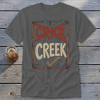 Dark grey t-shirt with "CRICK CREEK" text and a checkmark on a distressed sign.