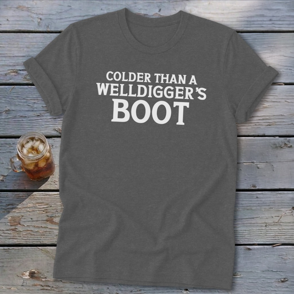 Dark gray t-shirt with white text reading "Colder Than A Welldigger's Boot."