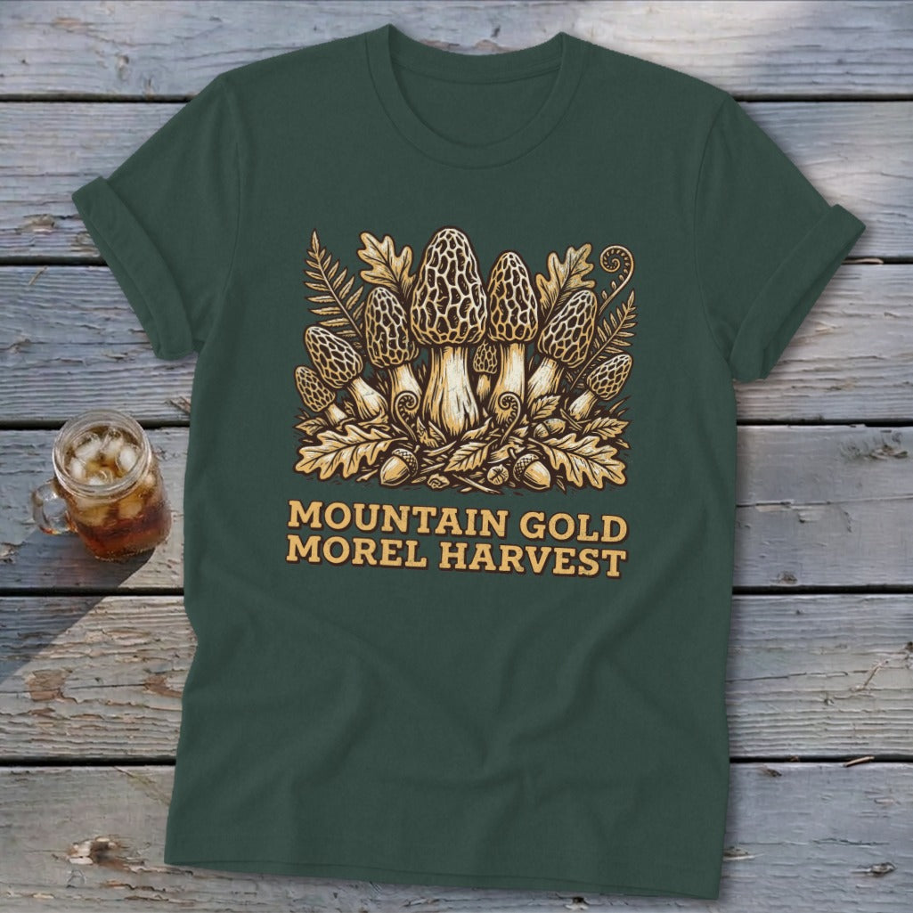 Dark green t-shirt with morel mushrooms, leaves, acorns, and "Mountain Gold Morel Harvest" text.