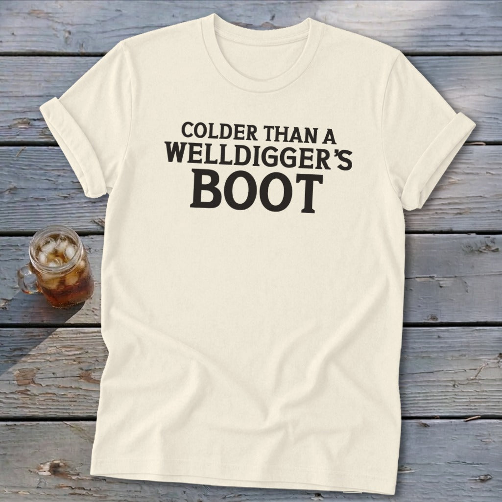 Cream t-shirt with black text reading "Colder Than A Welldigger's Boot".