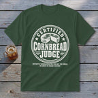 Dark green t-shirt with a white graphic reading Certified Cornbread Judge and a wheel of cornbread.
