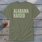 Olive green t-shirt with "ALABAMA RAISED" text in light green.