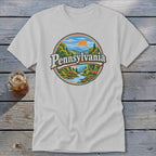 T-shirt with circular graphic of Pennsylvania landscape featuring mountains, river, deer, and text.