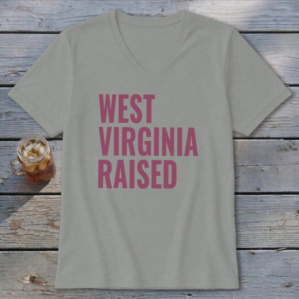 Gray v-neck t-shirt with pink text reading "WEST VIRGINIA RAISED".