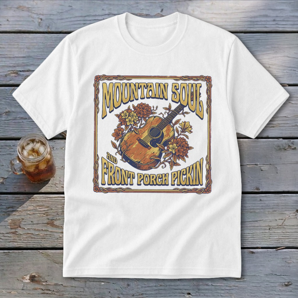 White t-shirt with "Mountain Soul and Front Porch Pickin'" text and acoustic guitar graphic.