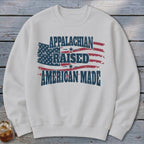 White sweatshirt with "Appalachian Raised American Made" text over a distressed American flag.