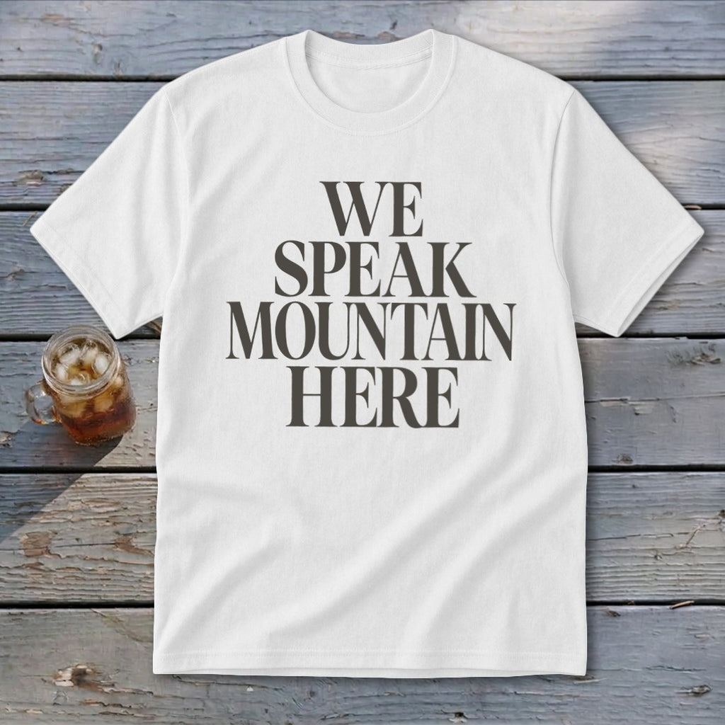 White t-shirt with "WE SPEAK MOUNTAIN HERE" text and a glass of iced tea.