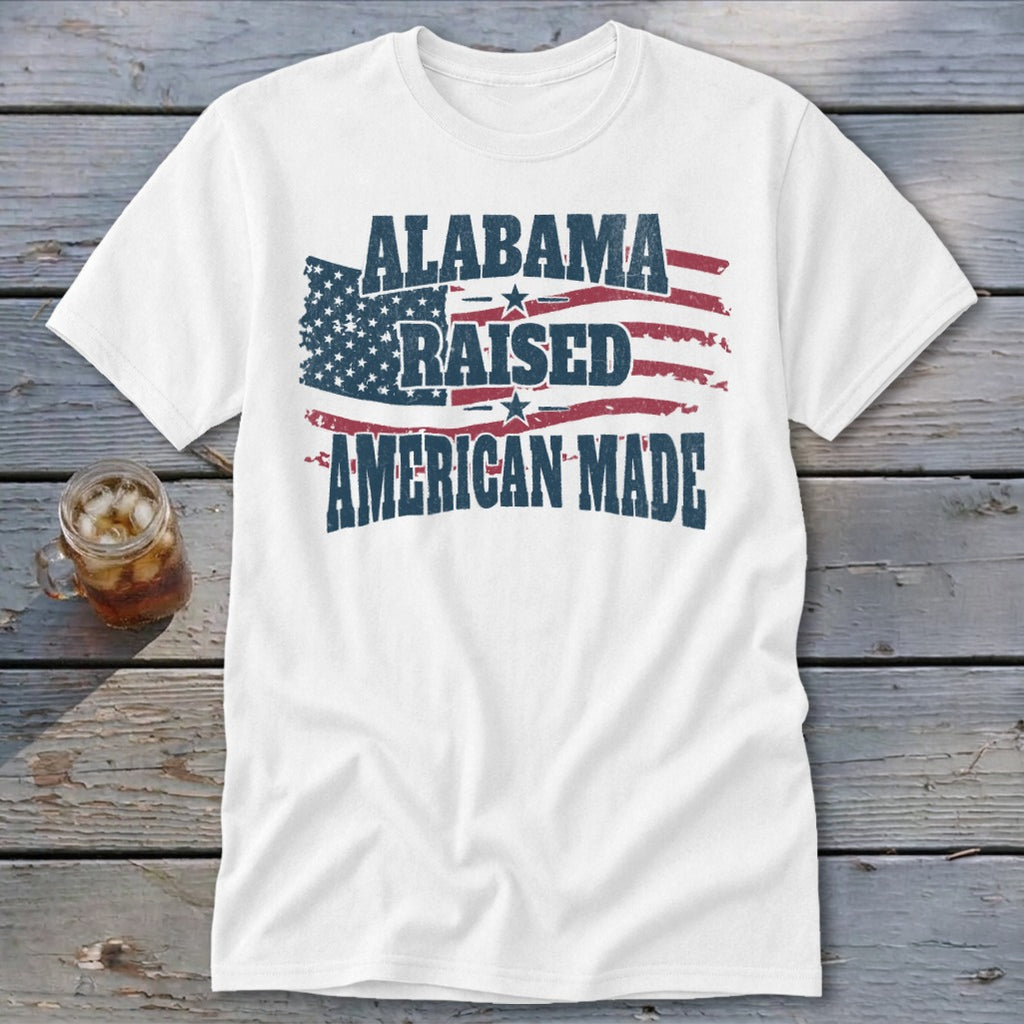 White t-shirt with "Alabama Raised American Made" text over a distressed American flag.