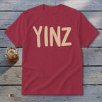 Maroon t-shirt with tan "YINZ" text.